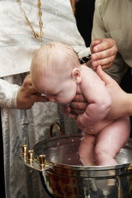 7421572-newborn-baby-baptism-by-water-in-font-with-hands-of-priest.jpg